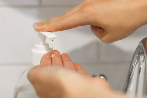istock Wash your hands! Applying antibacterial soap rom bottle on hands to prevent coronavirus. Cleaning and disinfecting hands in proper way. Using alcohol gel on palm for disinfection. 1220214593