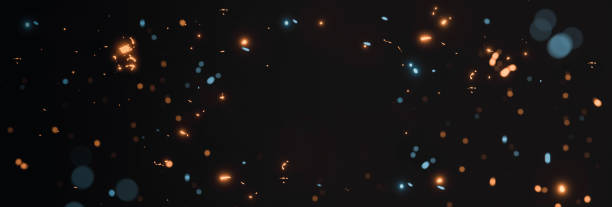 blurred yellow and cyan glow sparks from neon lights with blank spot on black backgound