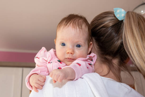 istock Happy baby girl on mother's shoulder. 1220217032