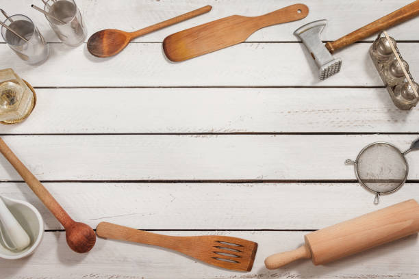 istock Wooden kitchen utensils form a background. They lie on boards painted white. 1220217104