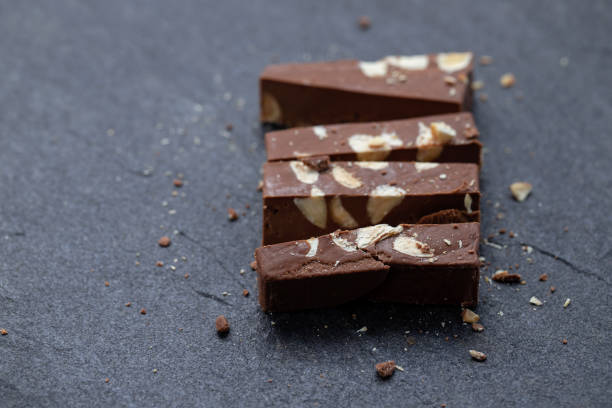 chocolate turron on ceramic background - torrone fotografías e imágenes de stock