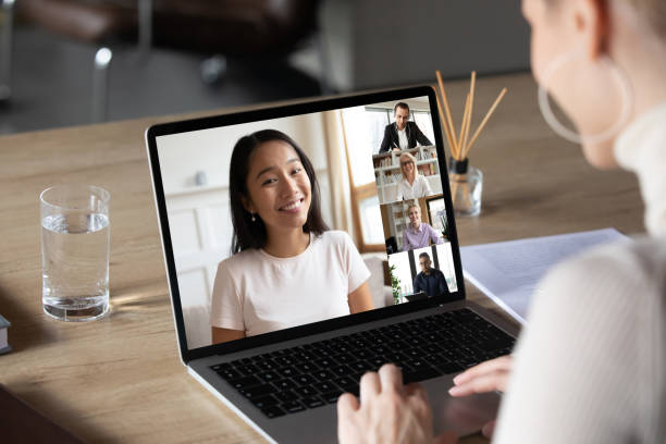 istock Asian woman and diverse colleagues taking part in group videocall 1220218276