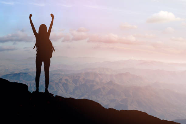 istock Woman Silhouette at sunset on hill stock 1220218664
