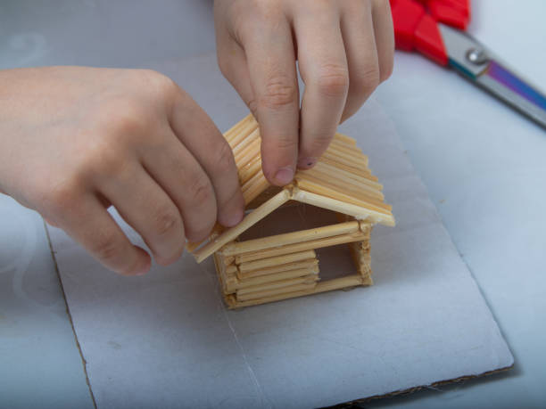istock step-by-step instructions for creating a house from bamboo sticks. children's creativity, manual work, online classes. 1220220163