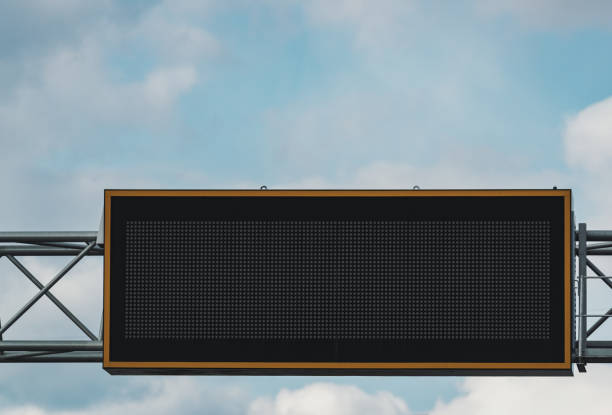 Blank overhead led road sign set against afternoon skies.