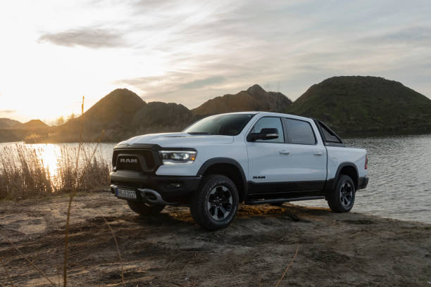 RAM 1500 pick-up next to lake in a sunset Berlin, Germany - 12 January, 2020: RAM 1500 Rebel stopped next to lake in a sunset. RAM is one of the most popular pickup vehicles in North America. ram stock pictures, royalty-free photos & images