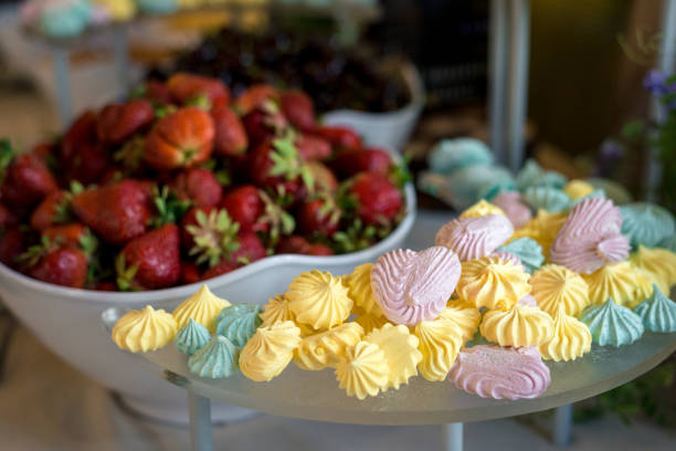 istock multi-colored marshmallows lies on a plate on a background of strawberries. horizontal frame 1220223336