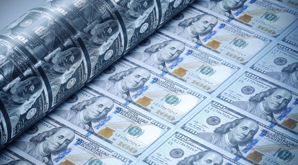 One Hundred American Dollars Being Printed - Money Printing Concept One hundred American dollars being printed. Selective focus. Horizontal composition with copy space. Money printing concept. currency symbol photos stock pictures, royalty-free photos & images