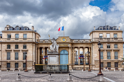 Paris, France - June 10 2019: Rear entrance of French National Assembly (Palais Bourbon) with Law statue in foreground. The statue is from Jean-Jacques Feuchere (1807-1852).