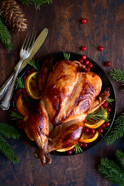 istock Roasted chicken with oranges ,rosemary and cranberries 1220227242