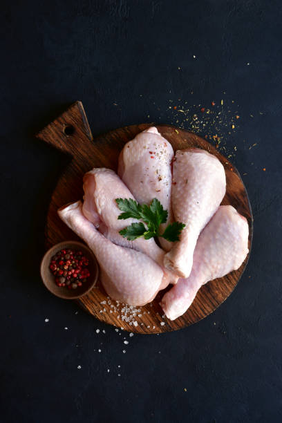 istock Raw chicken legs with spices 1220228410