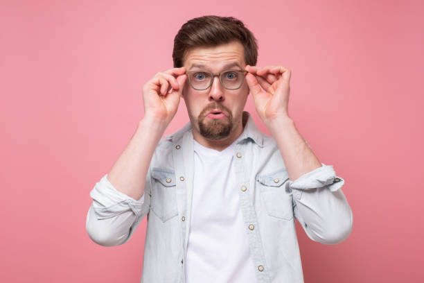 istock Amazed caucasian young man looking at camera through glasses 1220228460