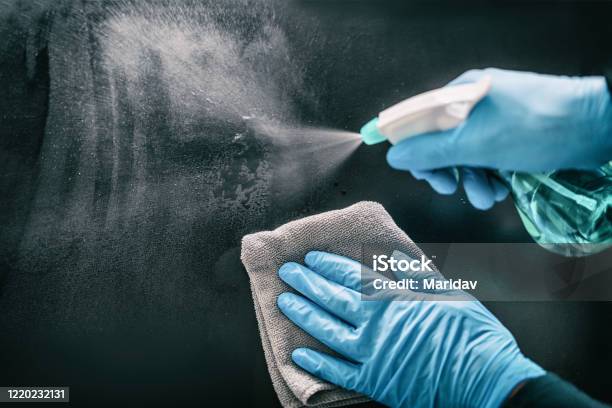 Surface Home Cleaning Spraying Antibacterial Sanitizing Spray Bottle Disinfecting Against Covid19 Spreading Wearing Medical Blue Gloves Sanitize Surfaces Prevention In Hospitals And Public Spaces Stock Photo - Download Image Now