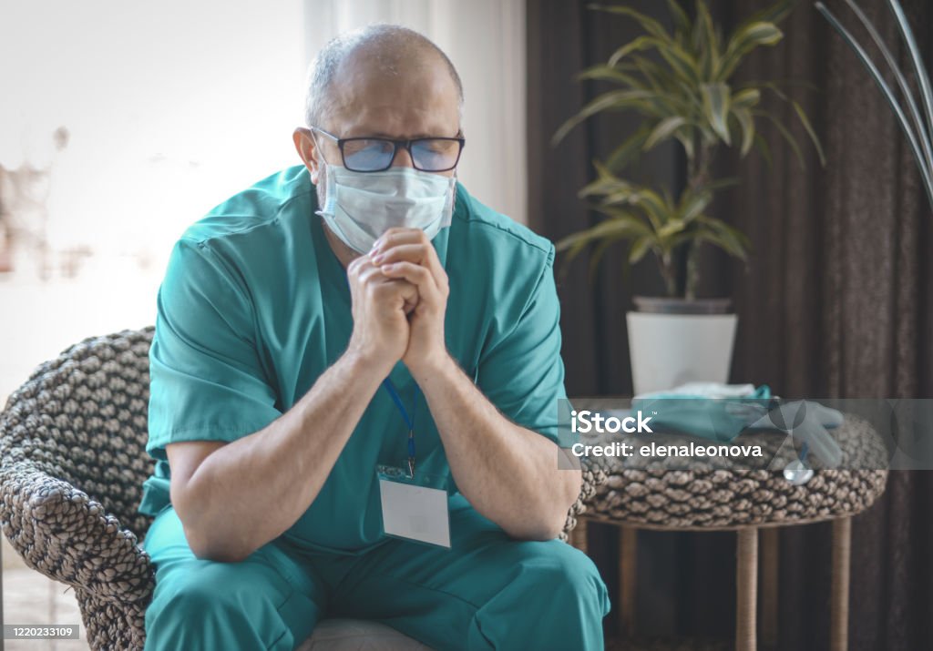 doctor surgeon in a surgical suit in a hospital restroom Coronavirus Stock Photo