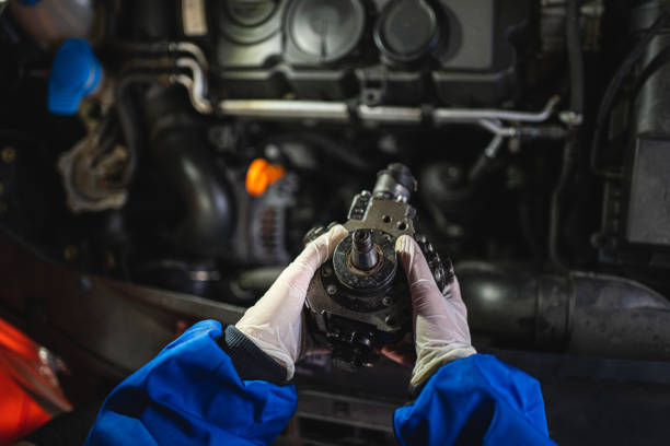 Car mechanic analyzing a car part Female mechanic checking the inside of the car hood for problems personal perspective standing stock pictures, royalty-free photos & images