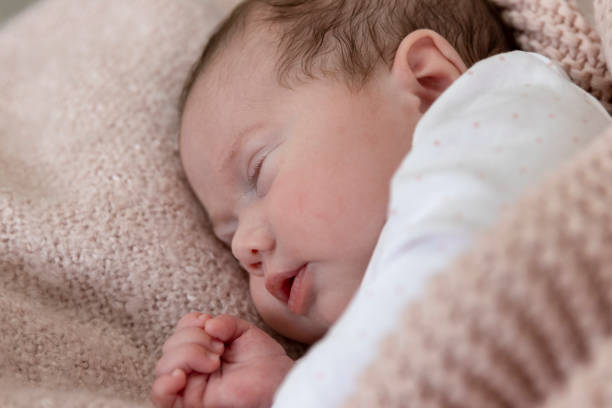 istock Baby girl sleeping in a crib 1220240525