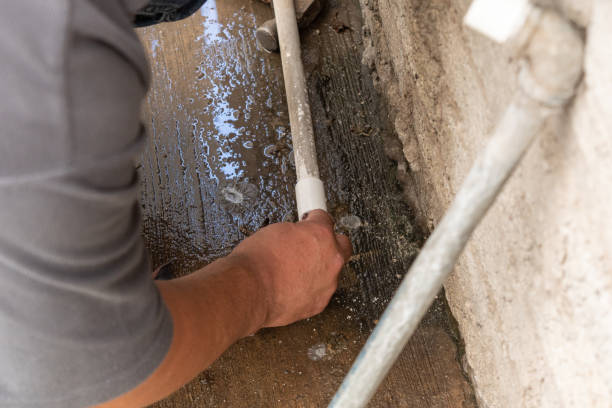istock An old man fixing a water tube 1220241692