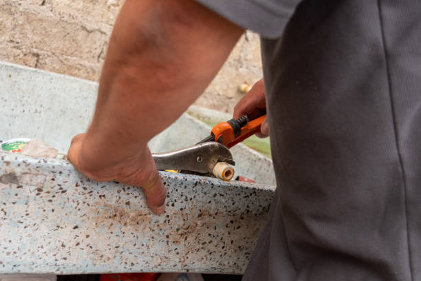 istock An old man fixing a water tube 1220241767