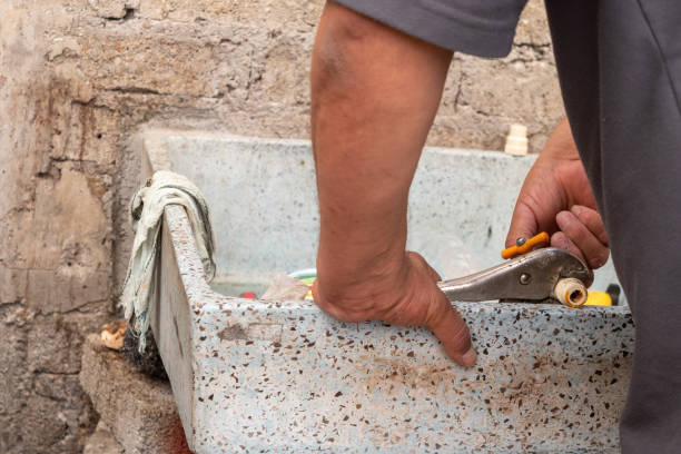 istock An old man fixing a water tube 1220241859