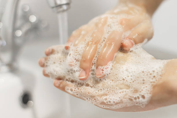 istock Wash your hands!  Washing hands with antibacterial soap in proper technique on background of flowing water in white bathroom. Prevention coronavirus. Cleaning and disinfecting 1220242561
