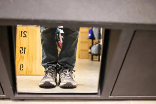 Photo of Trying to putting on shoes reflection on mirror