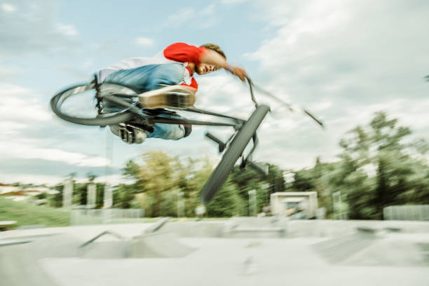istock bmx rider jumping over a ramp 1220247156