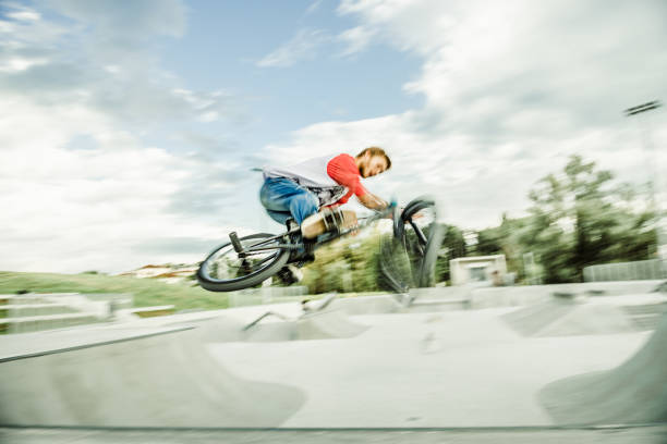 istock bmx rider jumping over a ramp 1220247182