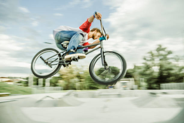 istock bmx rider jumping over a ramp 1220247183