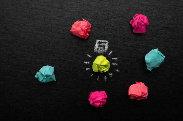 istock Good idea concept crumpled paper ball light bulb on blackboard with chalk 1220248086