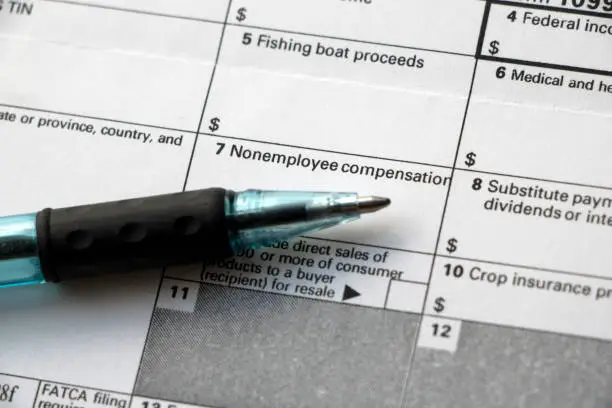 Closeup of the 'Nonemployee compensation' box on a Form 1099-Misc tax form with a pen.
