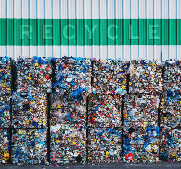 Plastic Recycling Large bundles of plastic bags, cans and milk containers await processing at a recycling center.  Added text above. stackable stock pictures, royalty-free photos & images