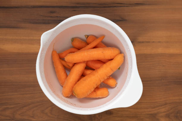 istock Cleaning carrots during the coronavirus pandemic outbreak 1220251060