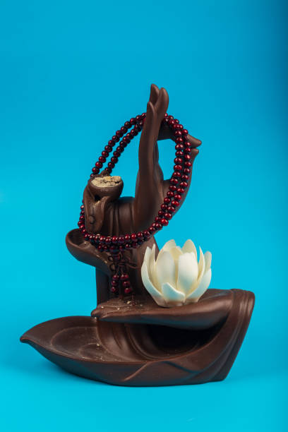 istock Beautiful Buddha hand for home decoration isolated on blue background 1220253164