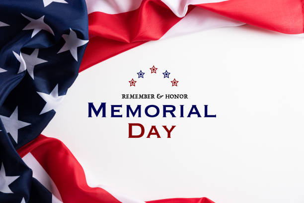 istock Happy Memorial Day. American flags with the text REMEMBER & HONOR against a white background. May 25. 1220253333