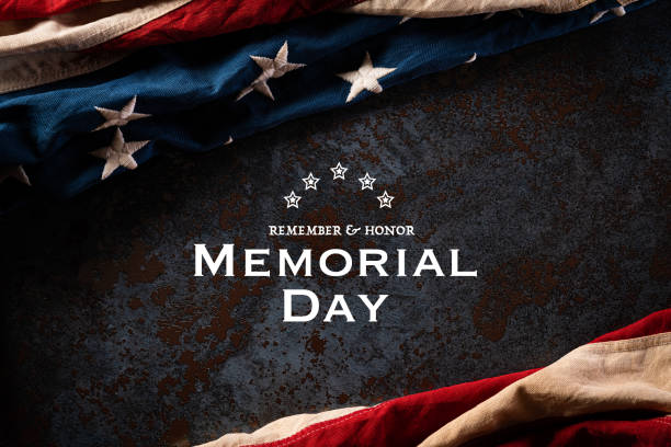istock Happy Memorial Day. American flags with the text REMEMBER & HONOR against a black stone texture background. May 25. 1220253337