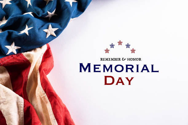 istock Happy Memorial Day. American flags with the text REMEMBER & HONOR against a white background. May 25. 1220253349