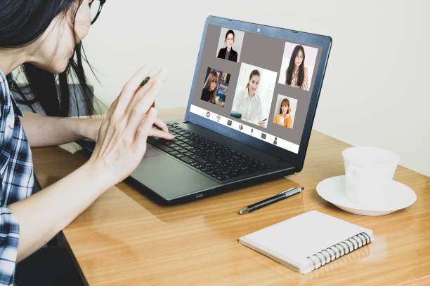 istock Laptop screen view over shoulder asian woman talking about work,sitting in work desk make video call have distant communication using videoconference app work from home to prevent corona virus 1220256740