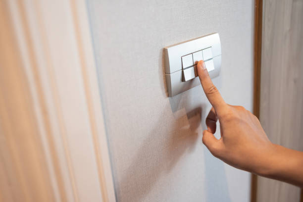 istock Close up of finger is turning on or off in light switch. 1220259271