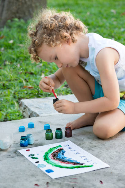 istock Toddler boy painting Stay Home message COVID quarantine 1220261462