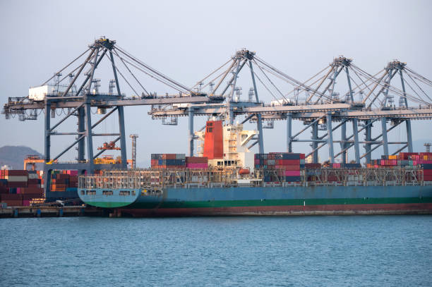 istock unloading containers of cargo ship. Logistic business concept. 1220262181