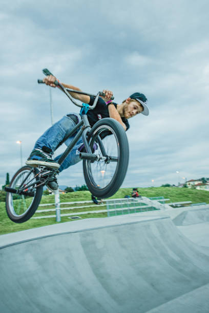 istock bmx rider jumping over a ramp 1220263600