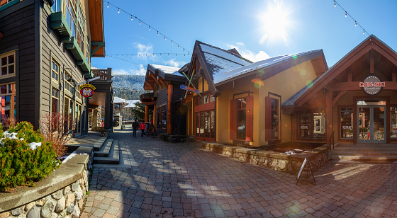 Whistler, British Columbia, Canada - March 11, 2020: Beautiful Panoramic View of Creekside Village on a small Touristic Ski Resort Town during a sunny winter morning.