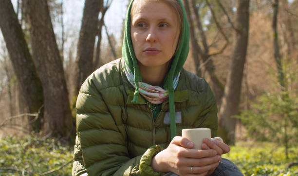 istock Woman drinking coffee in the forest 1220267581