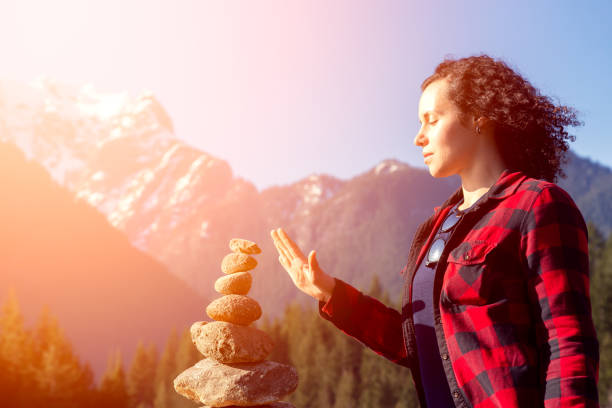 Girl in Canadian Nature Girl with Balancing Rocks on the beach by the Alouette Lake during a sunny winter day. Taken in Golden Ears Provincial Park, near Vancouver, British Columbia, Canada. alouette lake stock pictures, royalty-free photos & images
