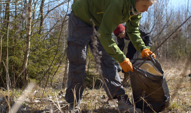 istock Eco activists picking trash in the forest 1220267661