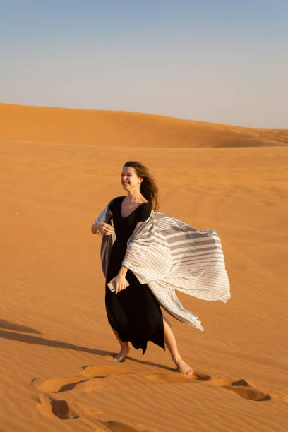 istock Girl dancing on the sand in the desert. 1220267776