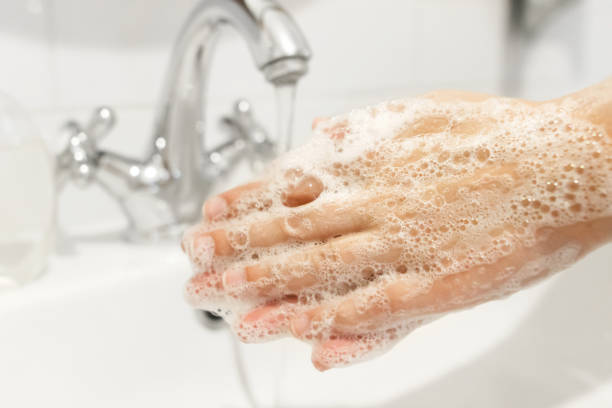 istock Wash your hands!  Washing hands with antibacterial soap in proper technique on background of flowing water in white bathroom. Prevention coronavirus. Cleaning and disinfecting 1220270294