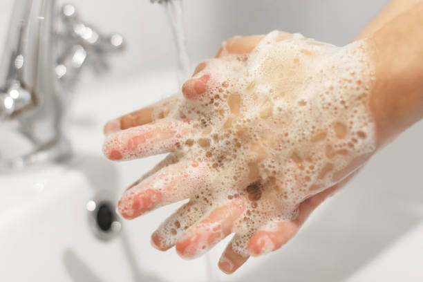 istock Rubbing fingers, Washing hands with antibacterial soap in proper technique on background of flowing water in white bathroom. Prevention coronavirus. Cleaning and disinfecting 1220270333