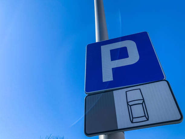 istock parking road sign on an iron pillar against a blue sky. 1220270431