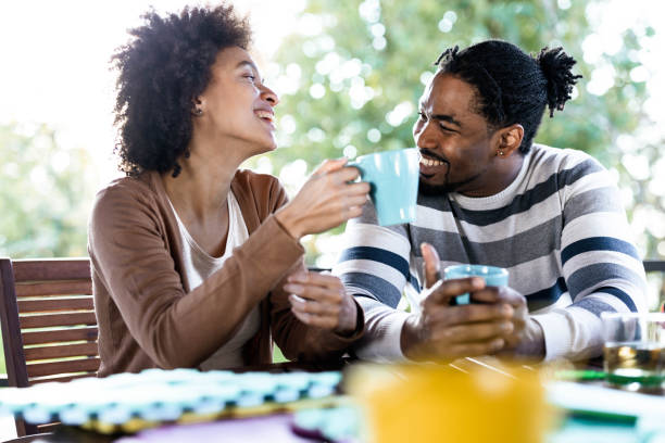 istock Happy black couple talking during coffee time on a terrace. 1220271010